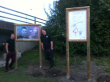 Marc and Warren with a poster in memory of their brother Josh designed by Marc and the other one designed by their little brother Harvey.