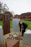 Izzy Roberts, designer of the Memorial, laying a stone