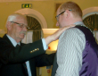 Outgoing Town Mayor, Cllr. John Kitwood, hands over the Mayoral Chain to Cllr. Edward Arnott